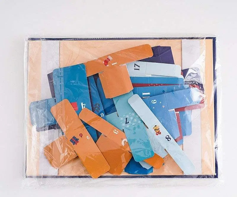 Gift Box with 24-Day Countdown featuring colorful numbered cartoon-style cardboard pieces for advent calendar assembly