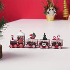 Wooden Train Christmas Decoration with Santa, tree, candy canes, and festive Christmas designs on red background