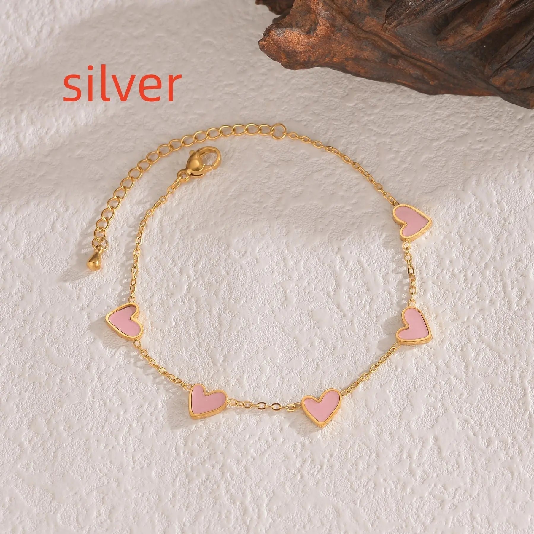 Gold plated love heart bracelet with pink enamel hearts on adjustable chain