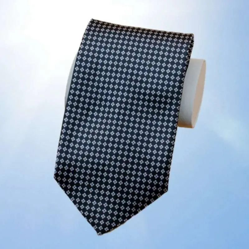 Black patterned men's tie from suit gift box set against light background