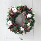 30cm Christmas wreath hanging decoration with pine cones, cotton, red berries, and ribbon accents on PVC garland
