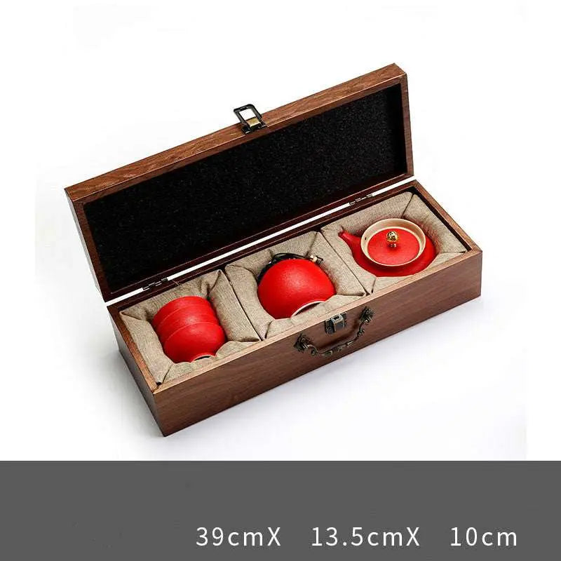 Ceramic Kung Fu tea set in red with wooden gift box, elegant and traditional design.