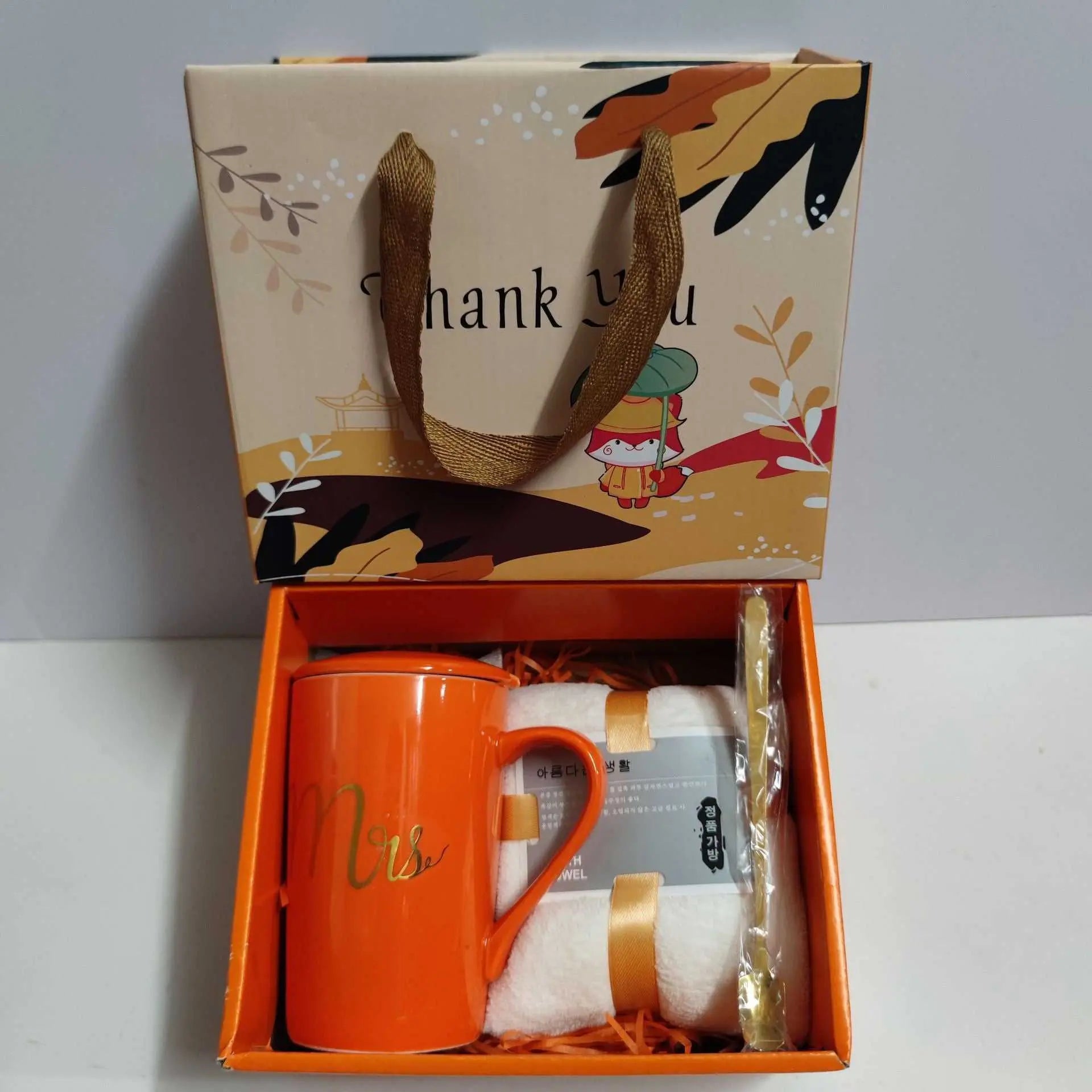 Orange ceramic cup gift box set with towel, spoon, and decorative thank you packaging