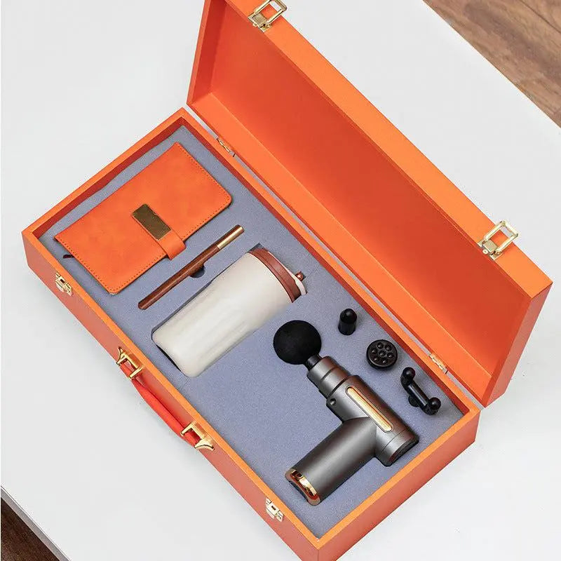Massage gun gift box set with ceramic tumbler, notebook, and pen in orange luxury case