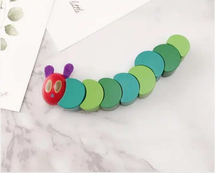 Colorful caterpillar-shaped toy on a marble surface