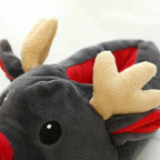 Close-up of a soft fleece Christmas elk slipper with beige antlers and red interior lining