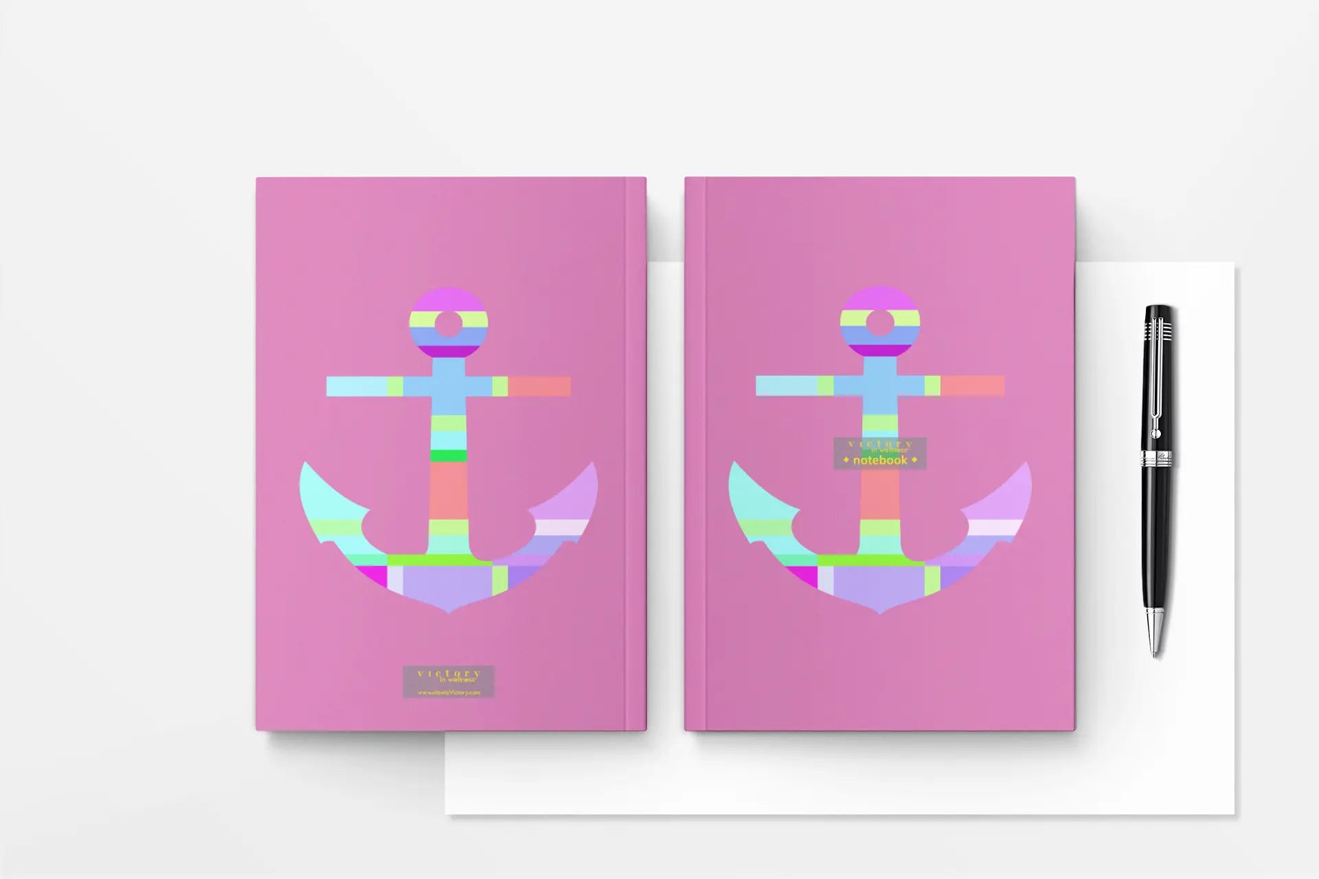 Pink Anchor Kids Notebook with colorful nautical anchor design and pen on white background
