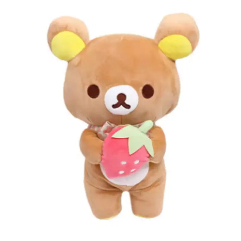 Plush toy bear holding a strawberry on a white background